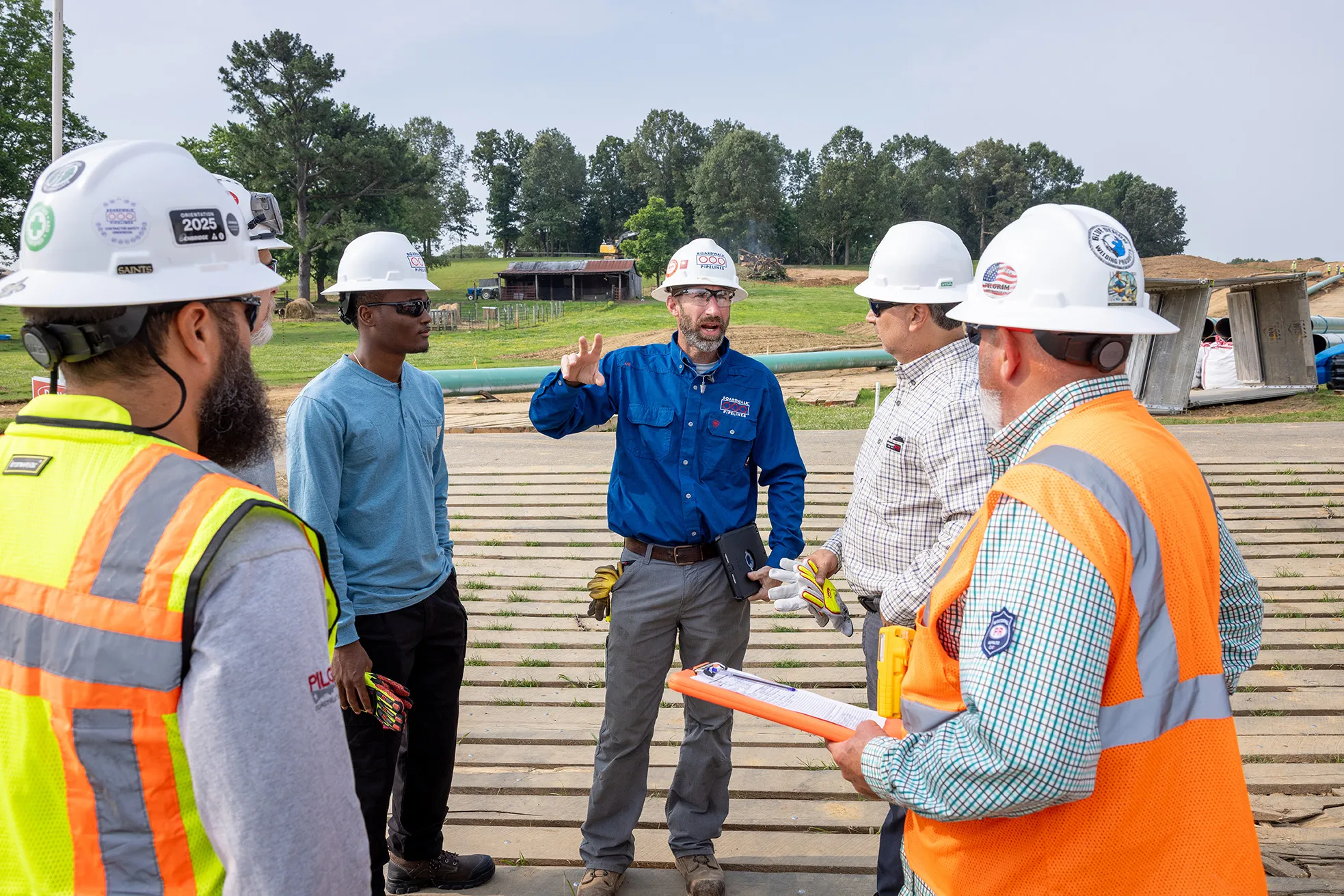 Boardwalk and contractor crews reviewing plans on a work site